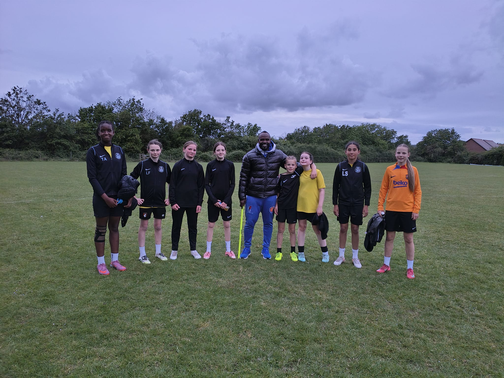 WNC coach with a youth squad after a grassroots training session