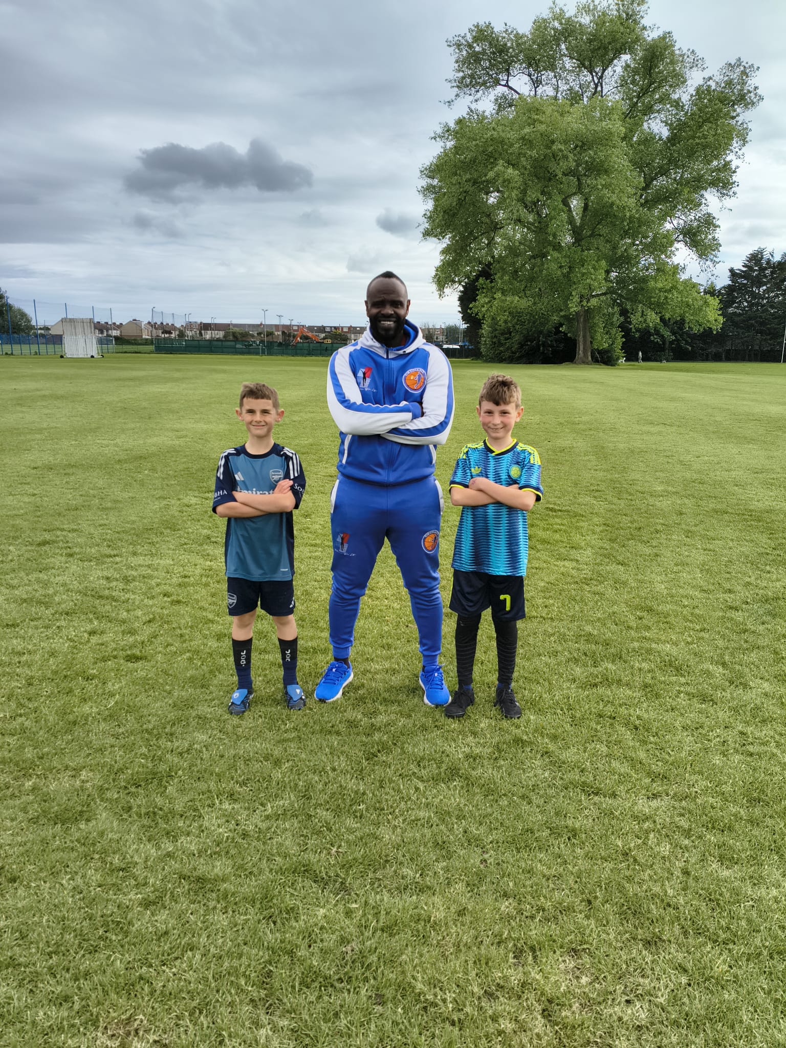 WNC coach with two young grassroots footballers at training